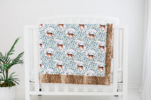 Farmhouse deer blanket hanging on crib
