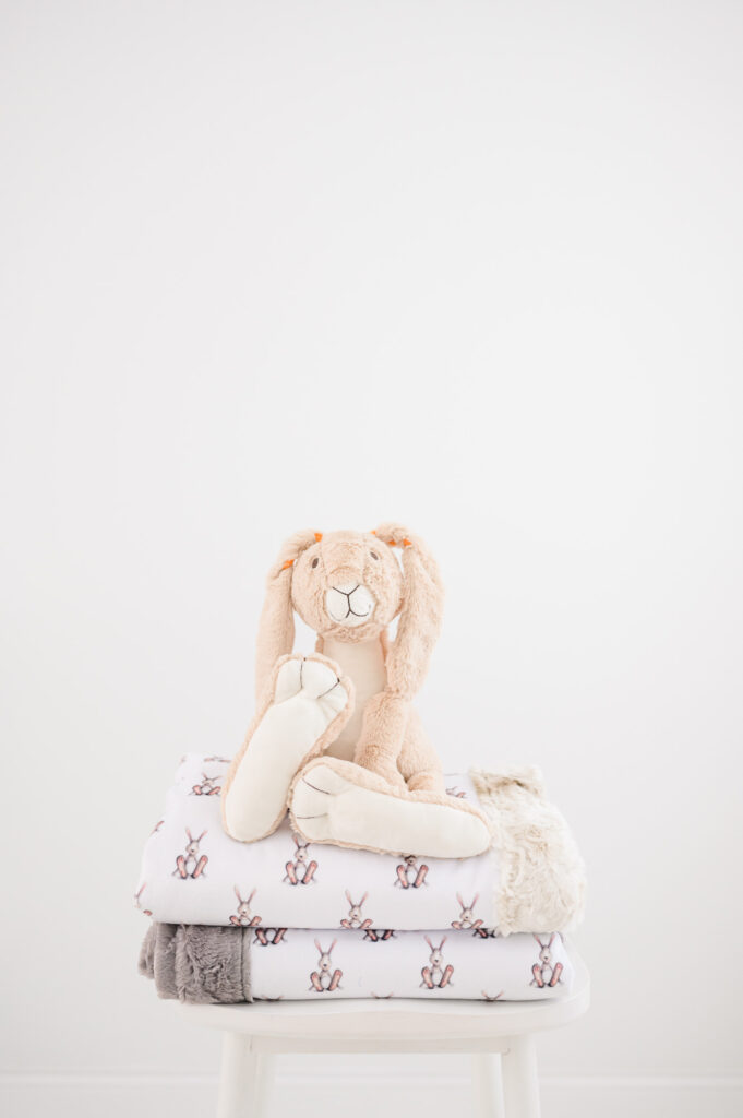 Baby blanket with bunny sitting on top