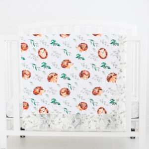 Hedgehog in spring blanket hanging on crib